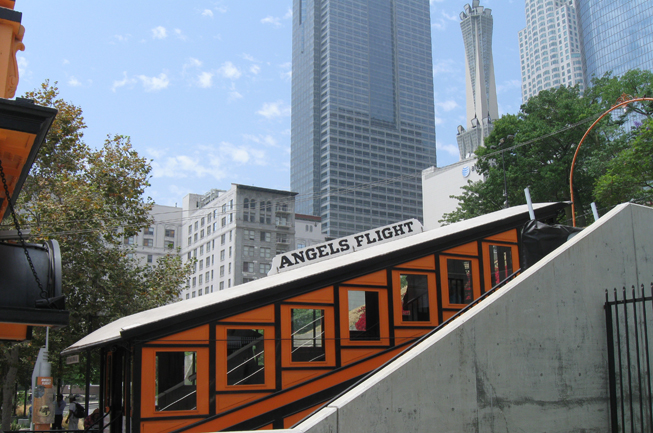 Orange Angels Flight ascends, with downtown skyline in the background.