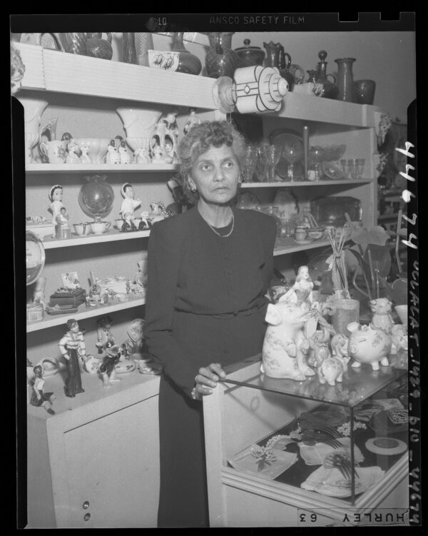 Because Mrs. Isabel Crocker, shown in her gift shop, is three-quarter American Indian, she and family must vacate their West Hollywood home, says court, owing to non-Caucasian deed restriction.