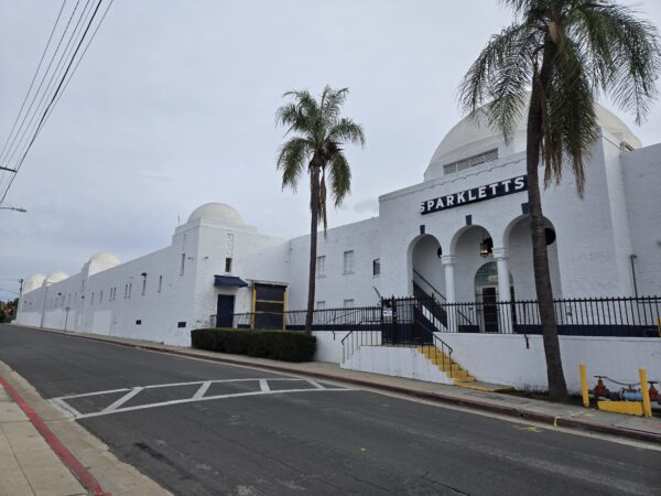 An oblique view of the Sparkletts Bottling Plant, showing the classical entry and industrial portions of the building