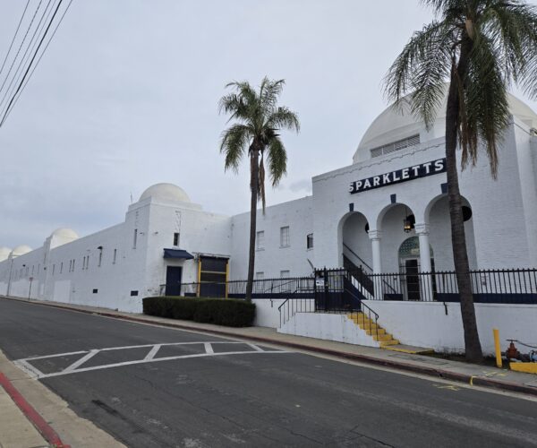 An oblique view of the Sparkletts Bottling Plant, showing the classical entry and industrial portions of the building