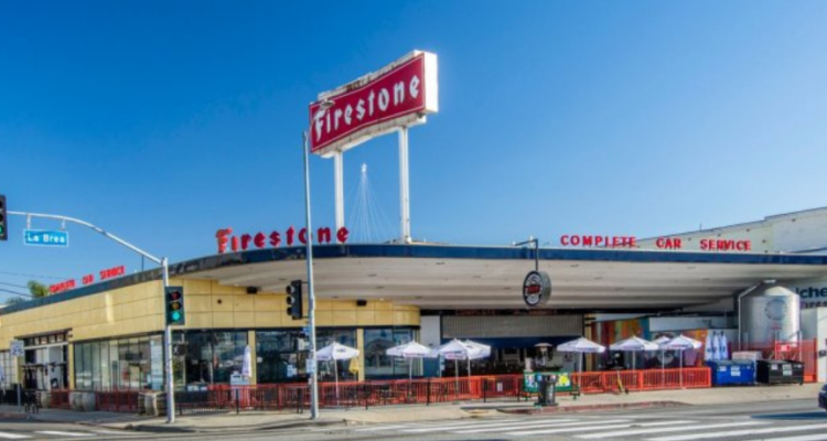 Corner view of a former Firestone tire and service station adaptively reused as a brewery.