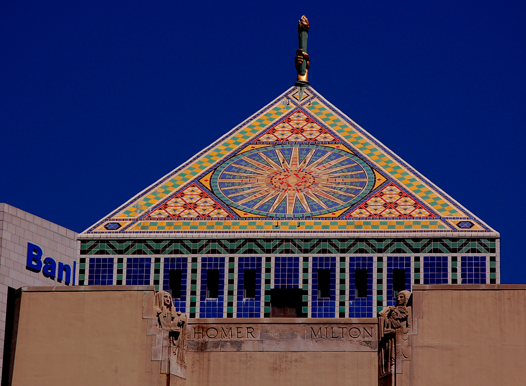 Pyramid roof of the central library covered in a bright mosaic against a blue sky