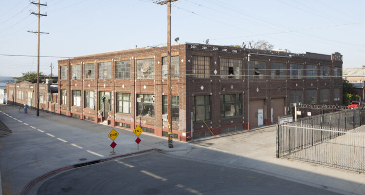 Corner view of two story brick industrial building