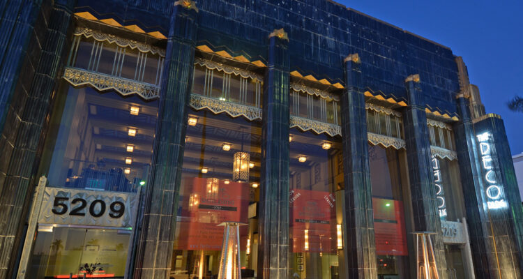 The Deco building at night with lights on