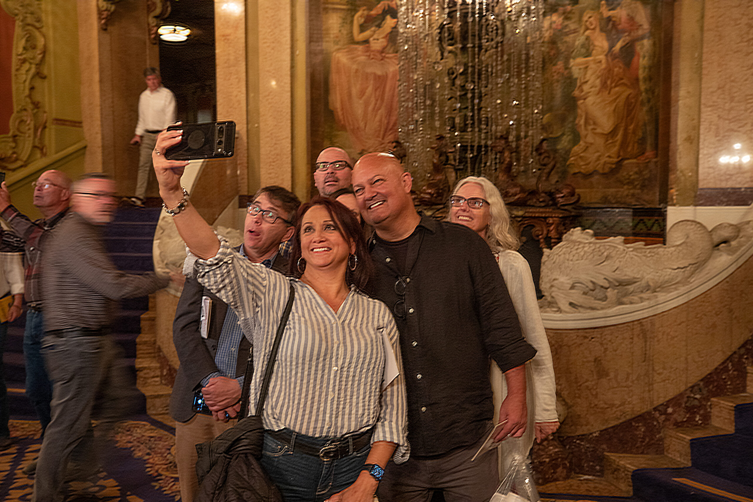 Guests at Last Remaining Seats take selfies in the historic L.A. Theatre.