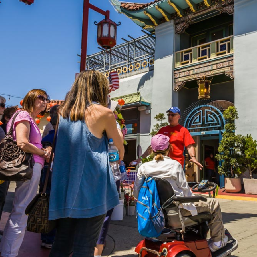 Tour guide shares the history of L.A.'s Chinatown to tourgoers.