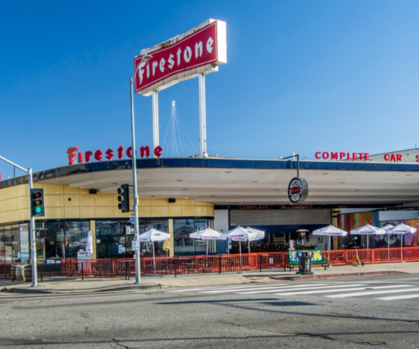 Corner view of a former Firestone tire and service station adaptively reused as a brewery.