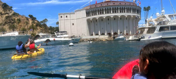 Heritage Project students kayaking with view of the Catalina Casino.