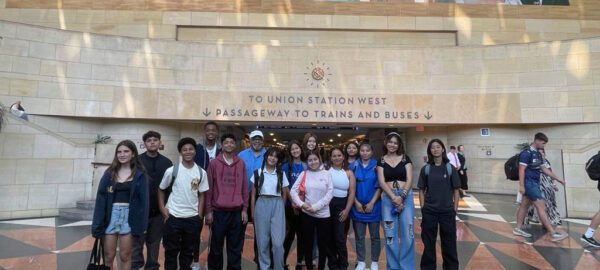 Heritage Project students posing in front of the union station west passageway to trains and buses.