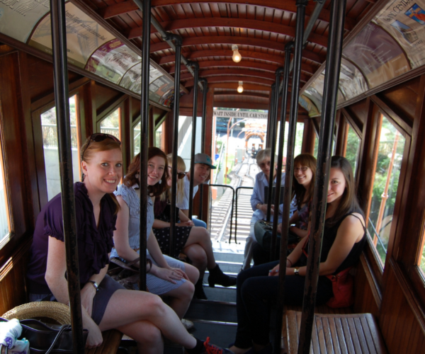 Group of smiling people riding Angels Flight in downtown L.A.