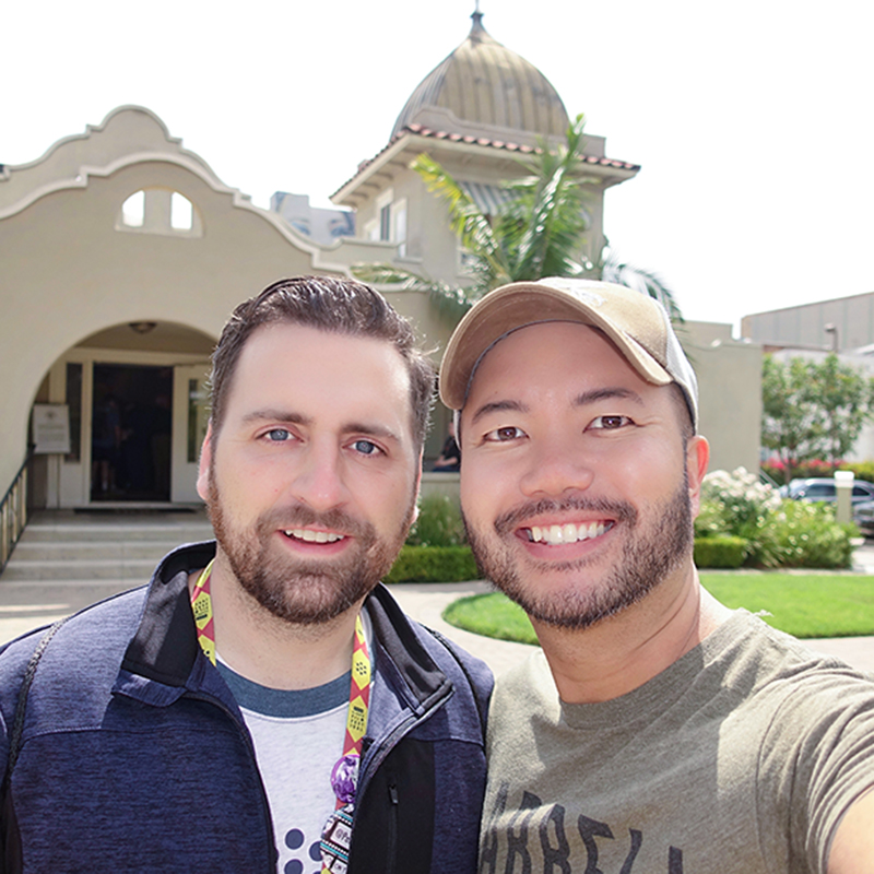 two men in front of house