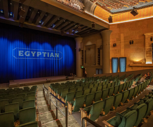 Green theatre seats with text of Egyptian on blue curtain backdropoff