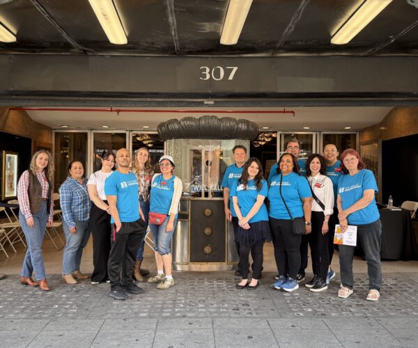 2025 Last Reaming Seats Committee Members celebrate outside the Million Dollar Theatre in August 2025