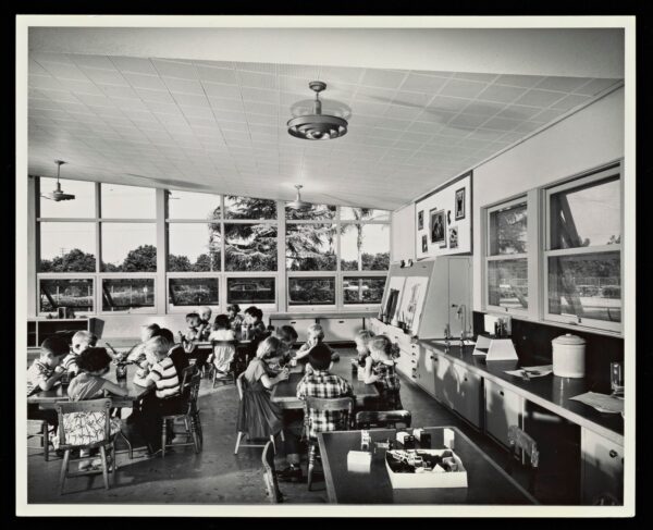 students working in classroom with large windows bringing light into the room