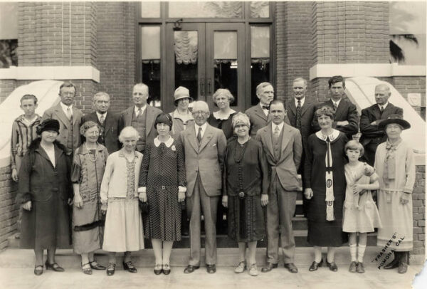 A group of people smiling and standing on steps posed for a picture.